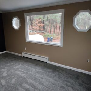 A residential room showcasing a new dark grey carpet installation by National Carpet and Flooring in Tyngsboro, MA.