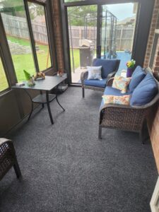 A newly installed dark grey carpet in a sunroom by Floor Coverings International Metro OKC in Moore, OK.