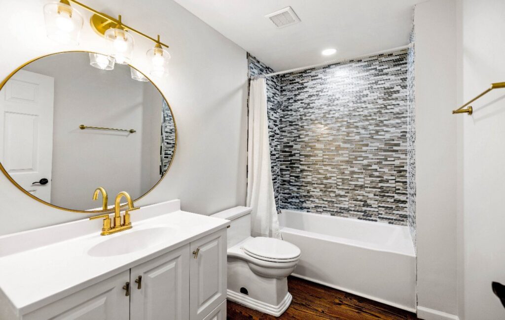 Elegant dark hardwood flooring in a renovated bathroom by Nations Best Flooring & Carpet Co. in Livonia, MI.