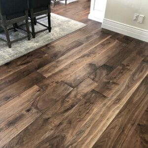 Newly installed dark hardwood flooring in a dining area by Carpets By Cal Inc in Vernal, UT