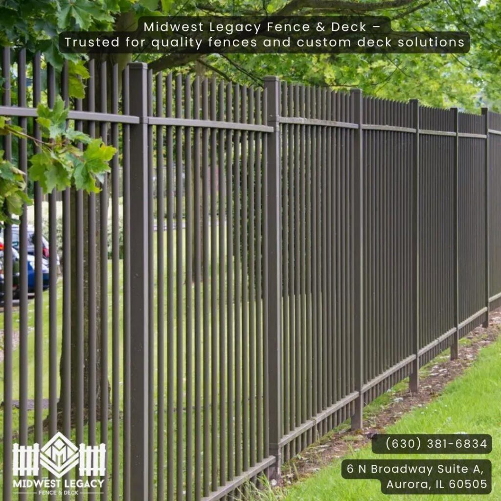 A dark metal picket fence installation by Midwest Legacy Fence & Deck, providing security in Aurora, IL.