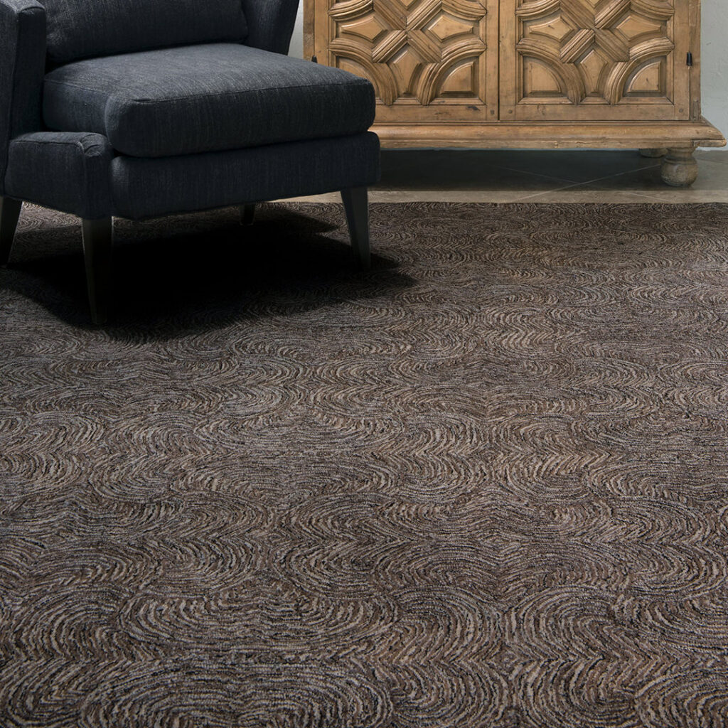 A room featuring a dark, subtly patterned carpet installation, showcasing work by Odino Designs, llc in Portland, OR.