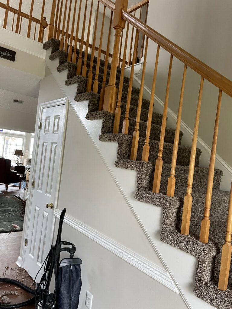 Professional installation of dark speckled carpet on a staircase by Johnson City Flooring & Finish, LLC in Johnson City, TN