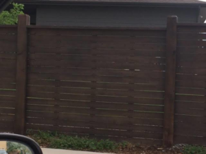 A dark stained horizontal wood fence providing privacy, expertly installed by Colorado Fence and Gate Systems in Colorado Springs, CO.