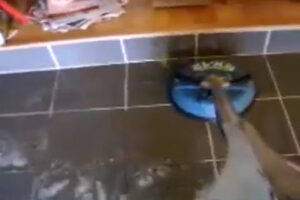 Professional cleaning of dark tile and grout, showing a distinct clean line, by A Copesetic Carpet, Upholstery, Tile & Grout Cleaner in Mesa, AZ