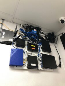 Network equipment, routers, and organized data cabling professionally installed on a wall by PTech Installs in Columbus, GA.