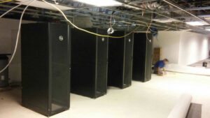 Room under construction with server racks and exposed ceiling wiring for data cabling setup by D & D Cabling Solutions in Arlington, TX.