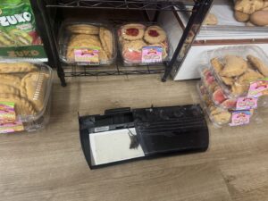 A dead mouse caught on a glue trap in a commercial bakery setting, demonstrating effective pest control by Charm City Pest Control Solutions LLC in Baltimore, MD.