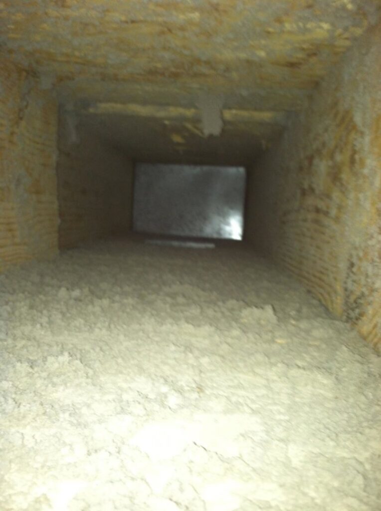 An air duct filled with debris and dust, requiring professional cleaning by Midwest Air Solutions in Indianapolis, IN