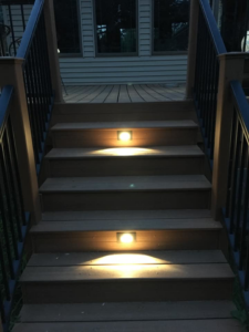 Deck stairs with modern step lighting installed by McPhillips Electric LLC in Columbus, NE, illuminating the path at night.