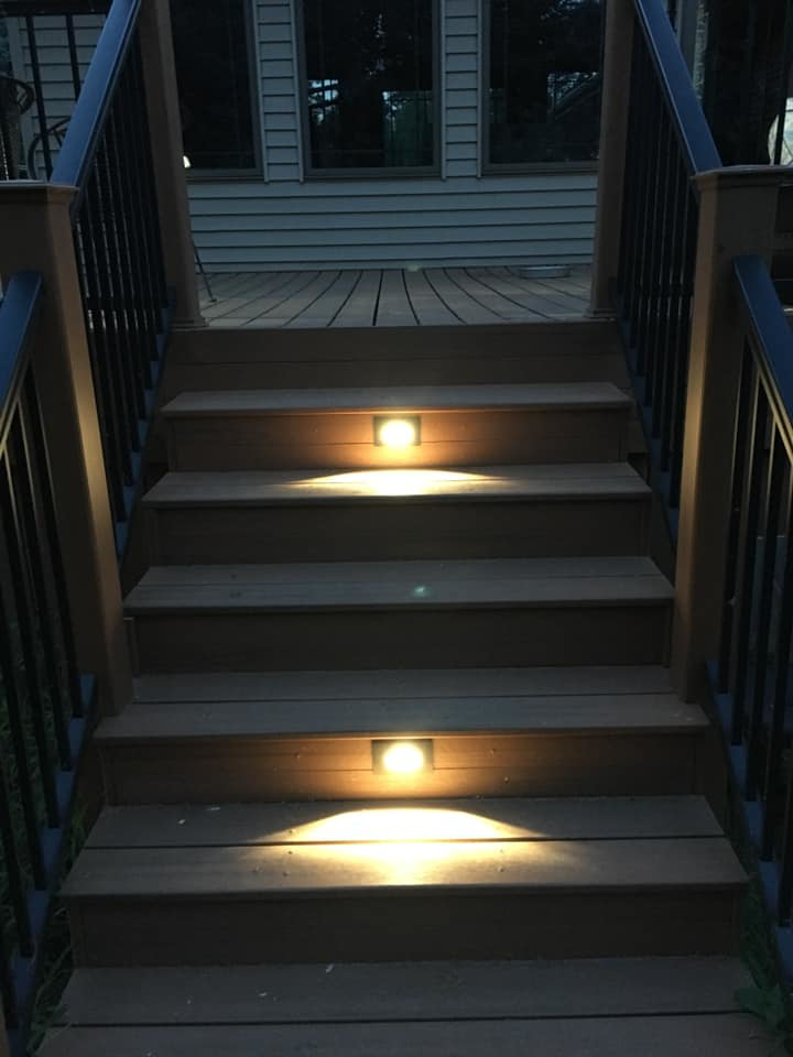 Deck stairs with modern step lighting installed by McPhillips Electric LLC in Columbus, NE, illuminating the path at night.