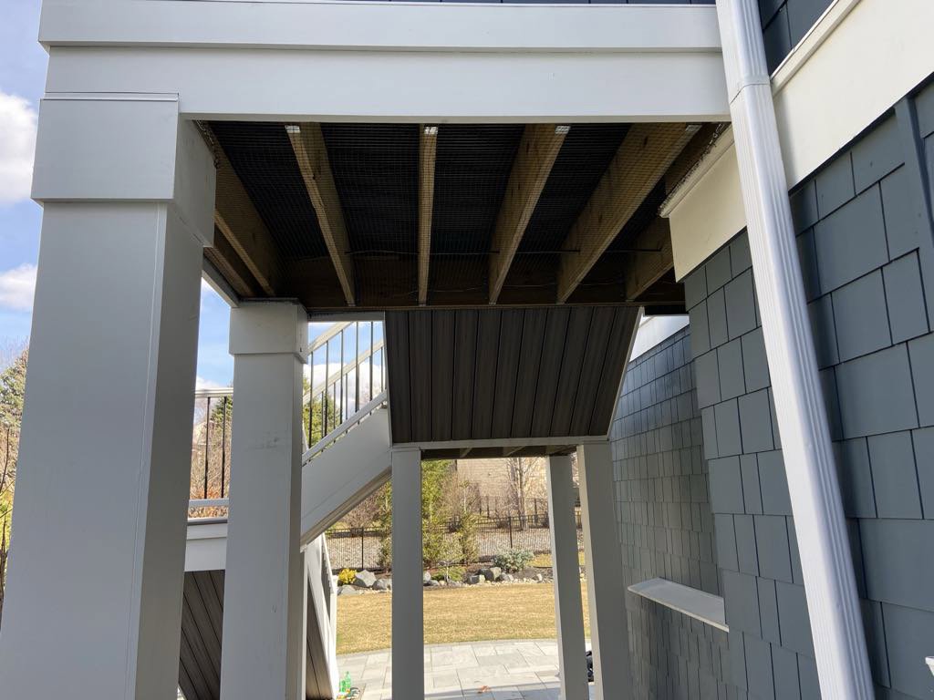 Wildlife exclusion mesh installed under a residential deck by Stellar Wildlife Solutions to prevent animal access in Cottage Grove, MN.