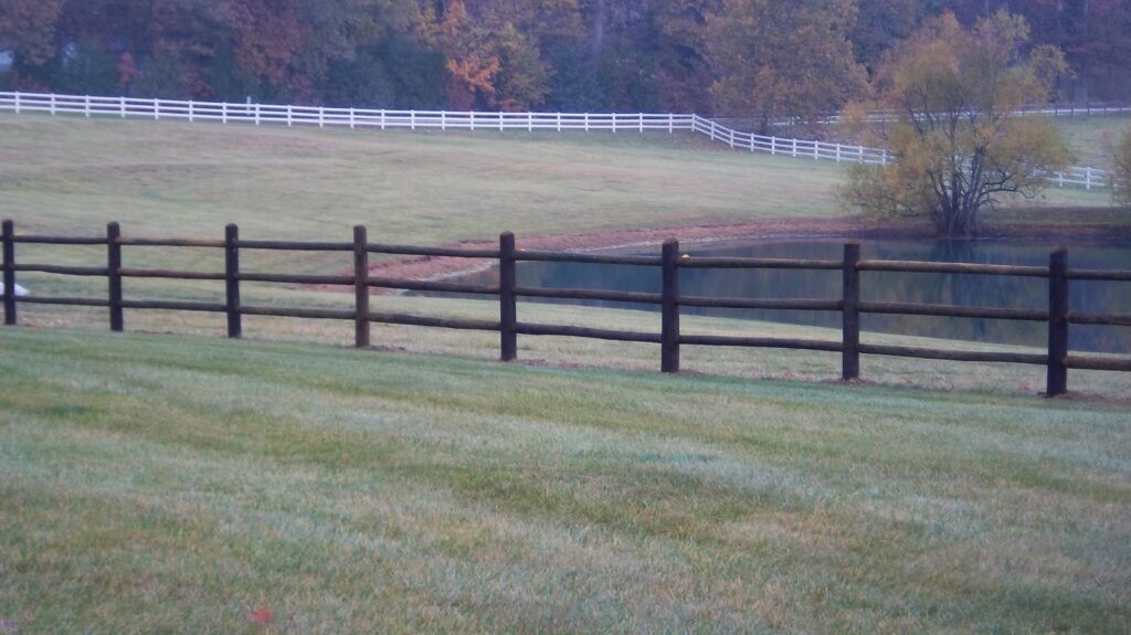 A spacious deck featuring a white pergola and matching railings, built by Custom Design Fence & Deck, Inc. in Ofallon, MO