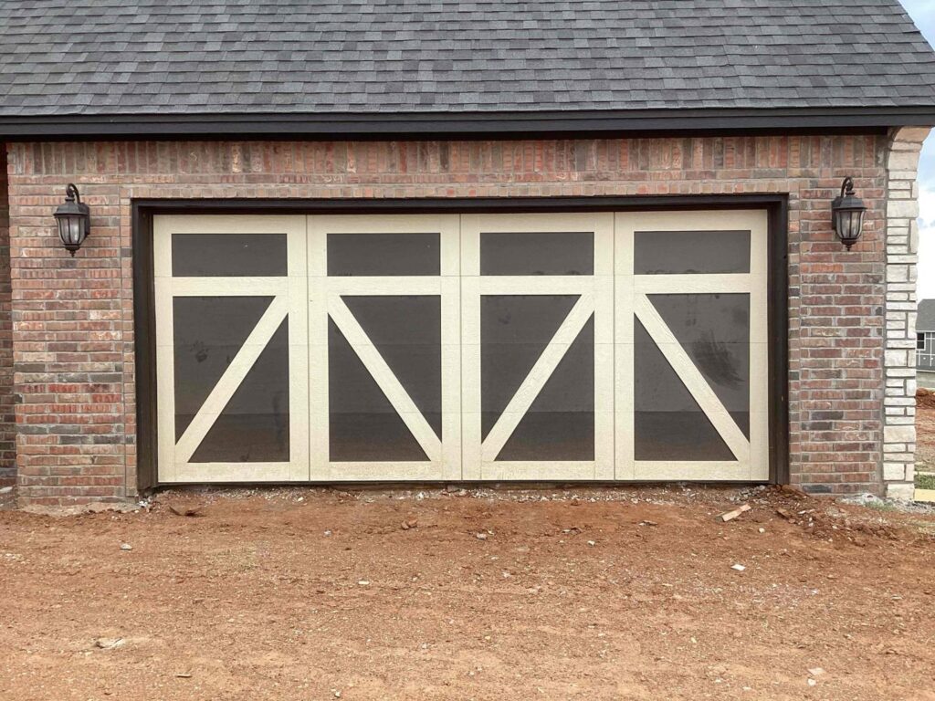 A decorative barn-style garage door installed in a new construction home by CCM Overhead Doors in Oklahoma City, OK.