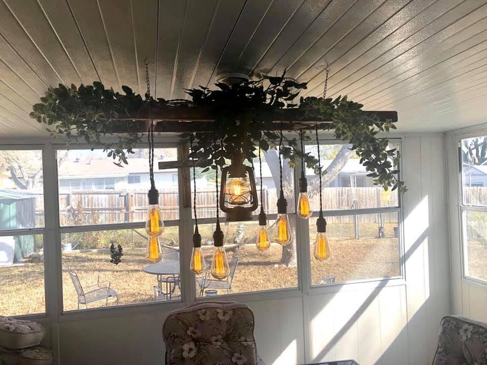 A large, decorative ceiling fan with lights installed in a sunroom by Calvert Electrical Service in San Antonio, TX