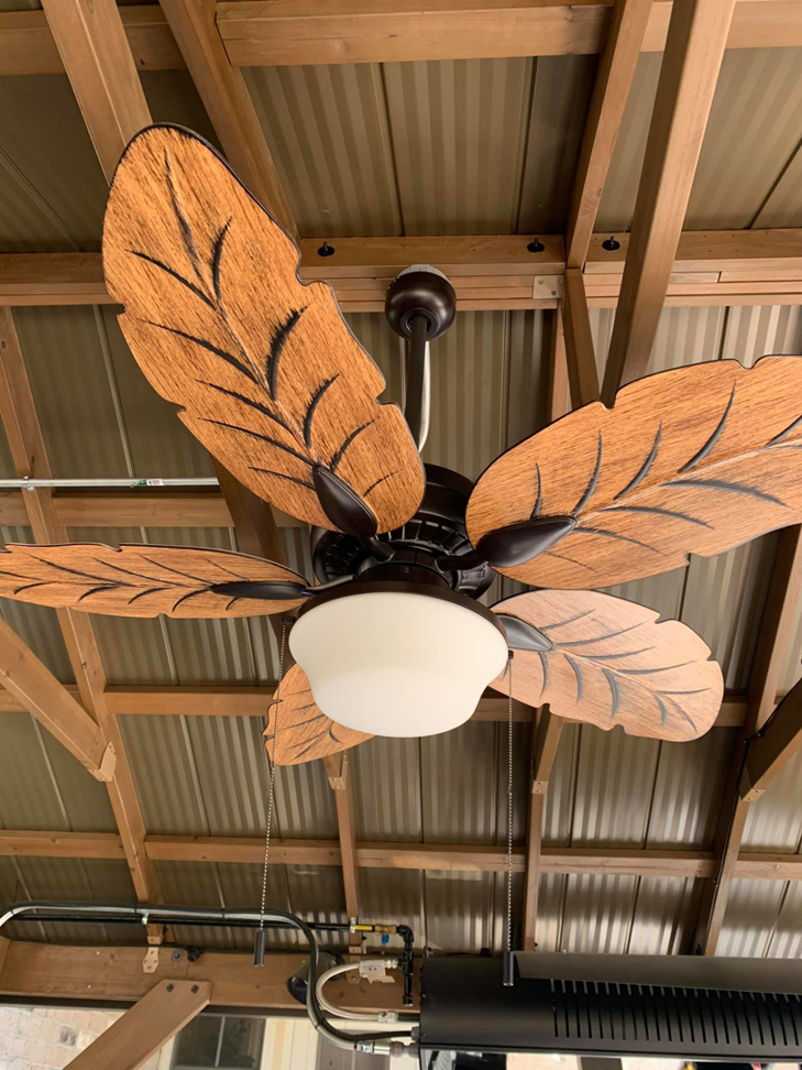 A decorative ceiling fan with leaf-shaped blades installed by Volt Doctors Raleigh, NC.
