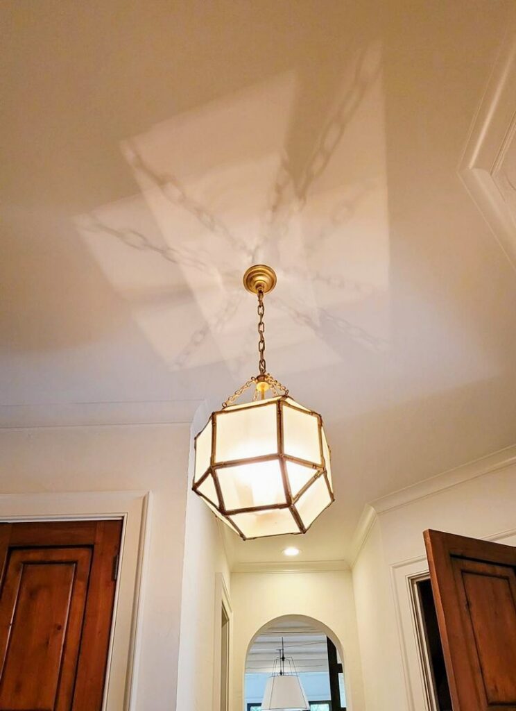 A decorative geometric ceiling light fixture casting patterns on the ceiling, installed by Corey N Craig Electric LLC in Charlotte, NC.
