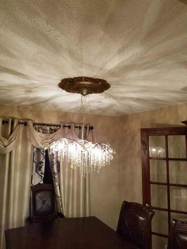 A decorative chandelier with a ceiling medallion installed by MDEC Electrical & Lighting in Livonia, MI.