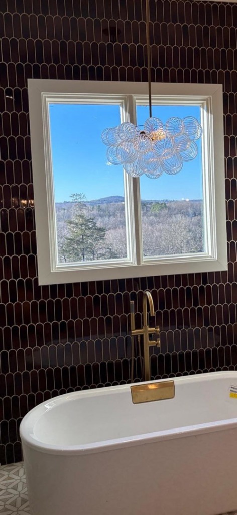 A decorative chandelier expertly installed in a bathroom, showcasing electrical fixture work by HMH Electric in Fayetteville, AR.