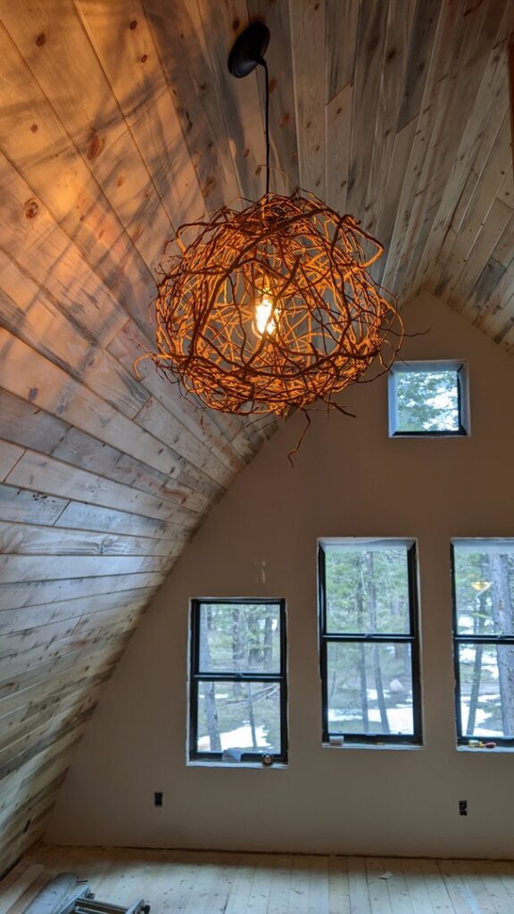 A unique decorative chandelier installed in a high-ceiling room by BlackRock Electrical in Pocatello, ID.