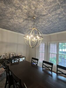 A decorative chandelier professionally installed in a dining room by Ardent Electric in Erie, PA.