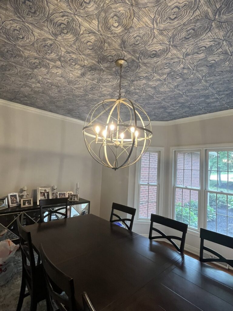 A decorative chandelier professionally installed in a dining room by Ardent Electric in Erie, PA.