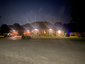 A house at night with decorative exterior lighting installed by Hammett Electric, Inc. in Conway, AR.