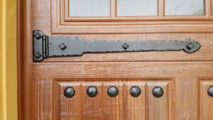 Close-up detail of decorative black hardware on a wood-grain garage door by Mountain Fox Garage Doors in Colorado Springs, CO.