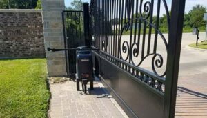 An automatic gate opener installed on a decorative black metal gate by Overhead Door Company of Maricopa & Pinal County in Mesa, AZ.