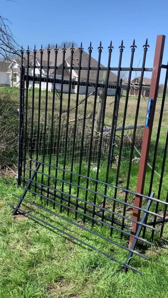 A decorative iron fence panel being installed or repaired by Iron Fence Services, LLC in Lancaster, TX