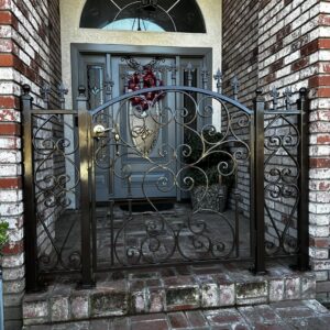 A decorative iron pedestrian gate at a house entrance, installed by Exclusive Custom Iron Works in Stockton, CA.