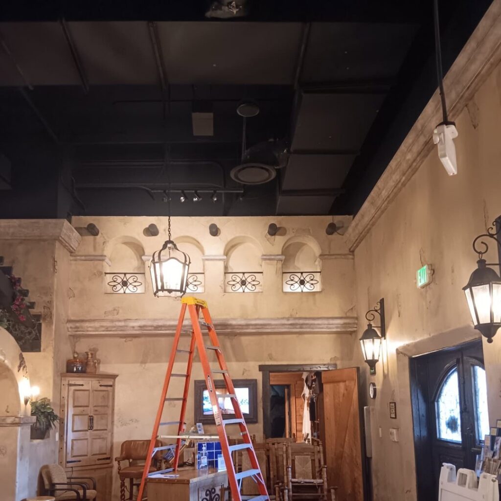 Decorative lighting installation, including wall sconces and a hanging lantern, by Ride the Lightning Electrical Services in El Cajon, CA.