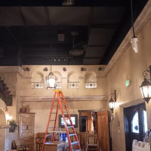 Decorative lighting installation, including wall sconces and a hanging lantern, by Ride the Lightning Electrical Services in El Cajon, CA.