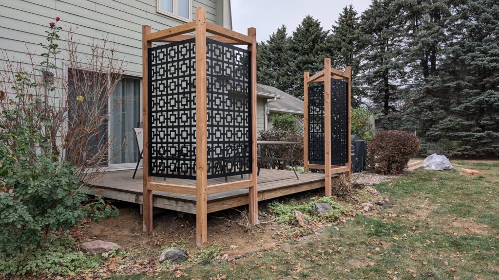 Two decorative privacy screens with geometric patterns on a deck installed by Babb Custom Fence in Sioux Falls, SD.