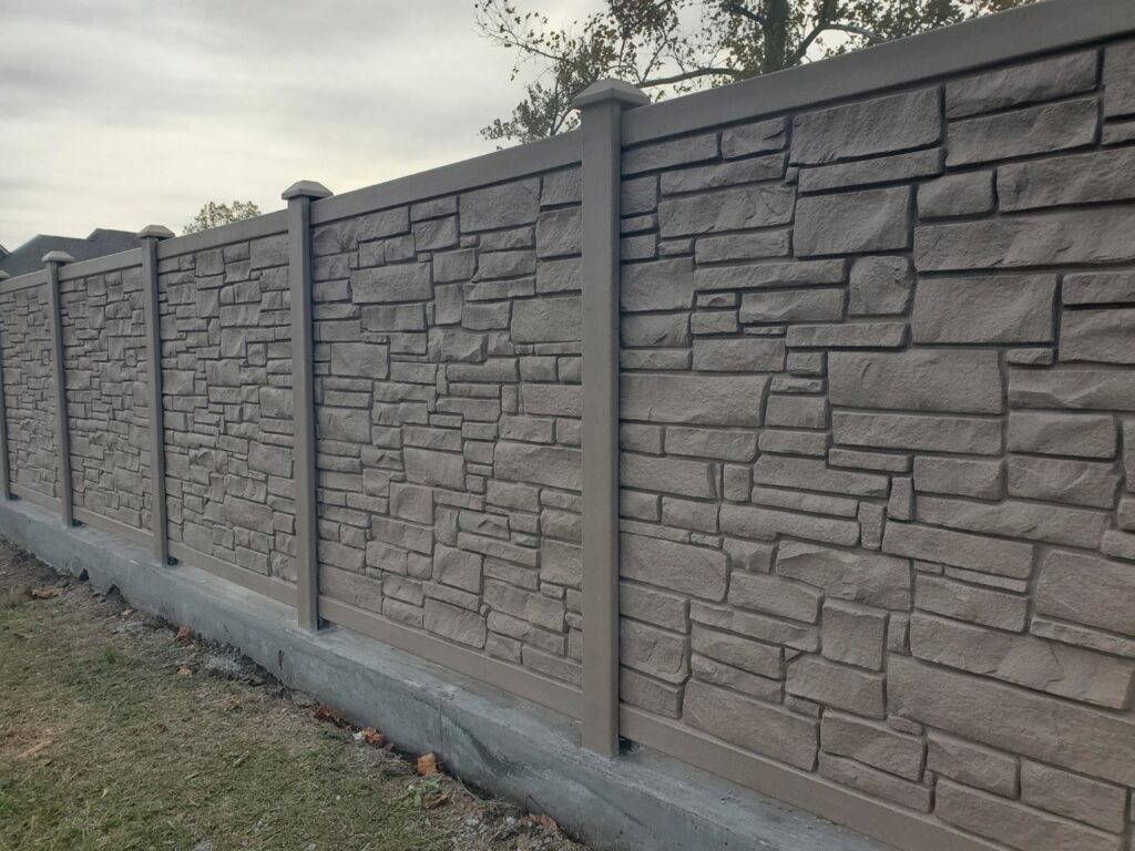 A decorative stone-look fence with a concrete base installed by 5-Alarm Fence Company in New Orleans, LA.