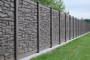 A decorative stone-look privacy fence installed in a residential area by Fence Company Chicago in Chicago, IL