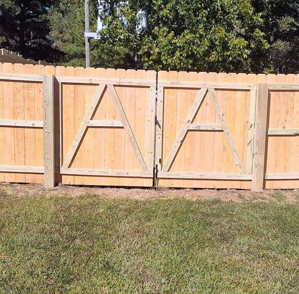 A decorative wood double gate with an 'A' pattern, expertly installed by Aguilarfence services LLC in Clayton, NC.