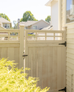 A custom decorative wood fence and gate installed next to a home by Alpine Fencing in Everett, WA.