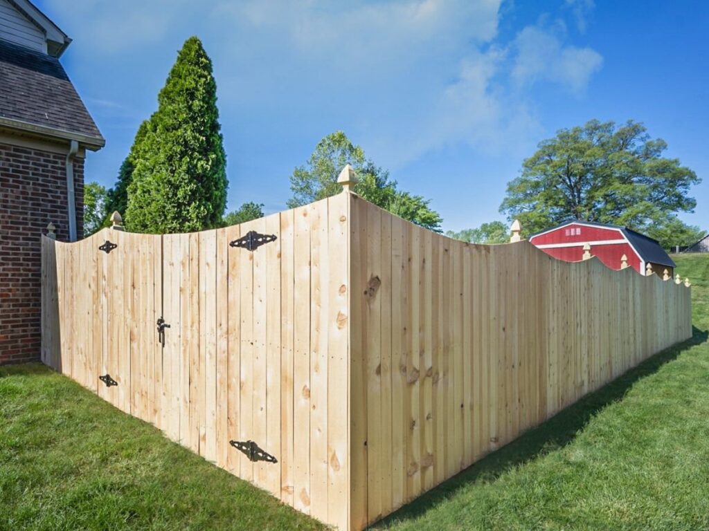 A decorative wood privacy fence with a stylish gate, installed by OneGuard Fencing in Vestavia Hills, AL.