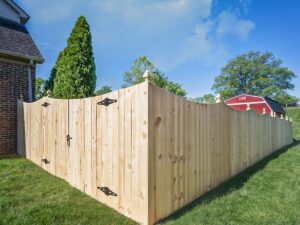 A decorative wood privacy fence with a stylish gate, installed by OneGuard Fencing in Vestavia Hills, AL.