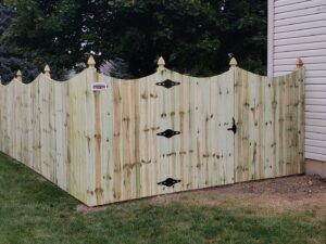 A newly installed decorative wood privacy fence with a gate by Sharper Image Fence in Fort Wayne, IN.