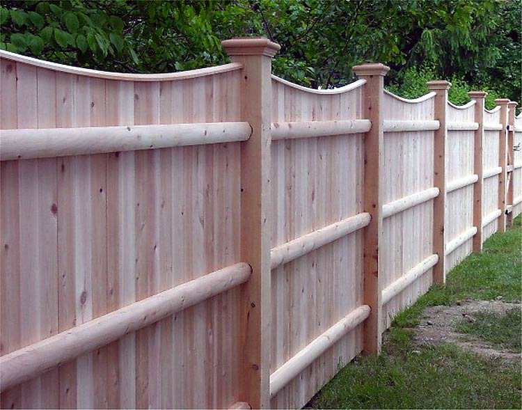 A close-up view of a decorative wooden privacy fence installed by OMA Fence,LLC in Weymouth, MA
