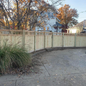 A decorative wood privacy fence with a lattice top installed by Rager Fencing & Lawn Care, LLC in Owensboro, KY.