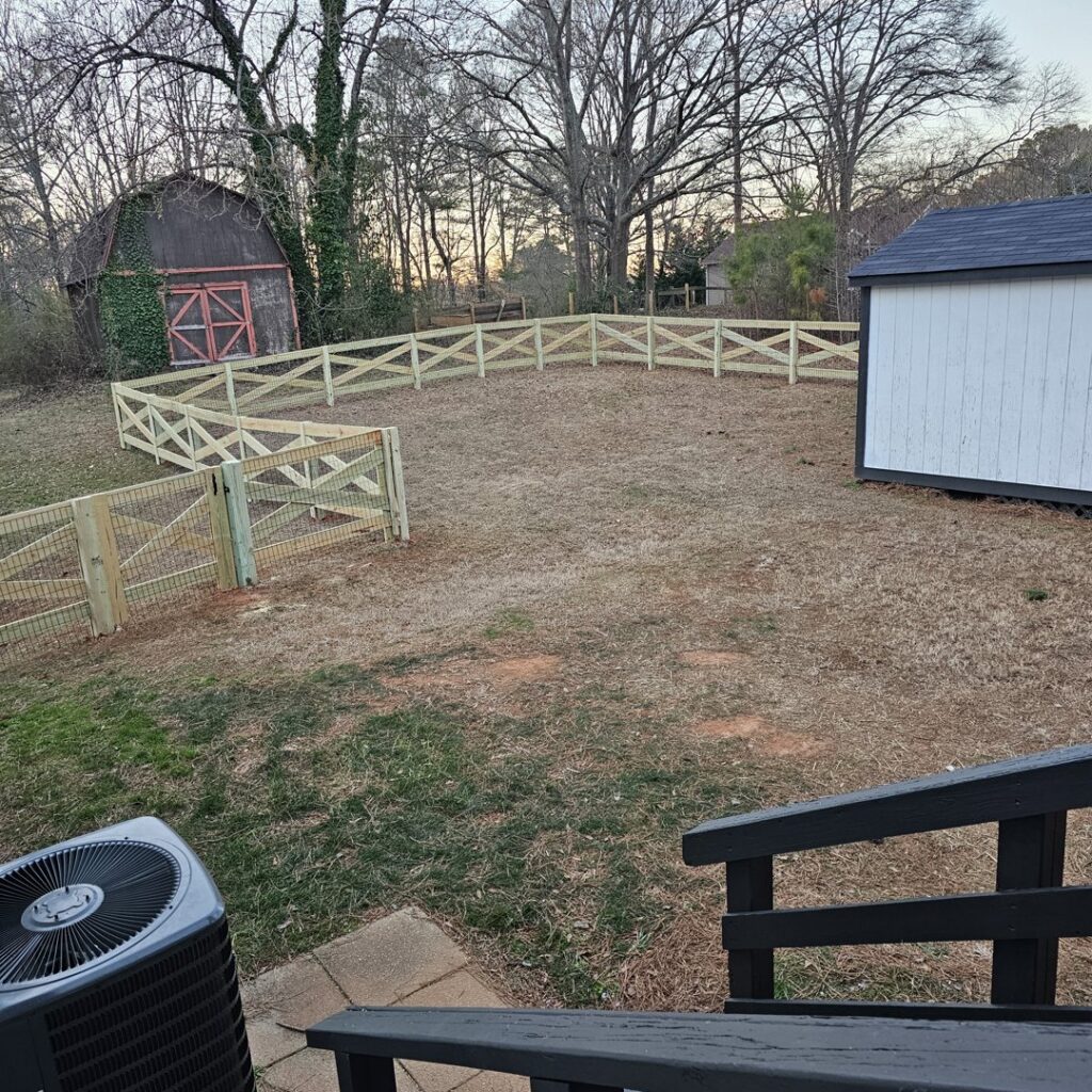 A decorative wood fence with wire mesh, perfect for a garden or pet enclosure, installed by Hawk Fences LLC in Johns Creek, GA.