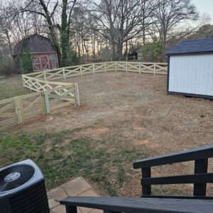 A decorative wood fence with wire mesh, perfect for a garden or pet enclosure, installed by Hawk Fences LLC in Johns Creek, GA.