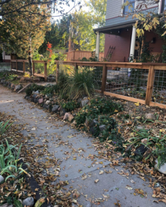 A decorative wood and wire mesh fence installed around a garden by Solid Fence LLC in Golden, CO.