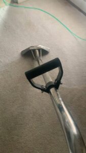 Deep carpet cleaning service being performed with a professional wand on a light grey carpet by Superior Carpet Cleaning in Greenville, SC.