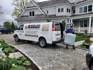 A Ziegler Preservation Cleaning van unloading carpet for service at a client's home in Danbury, CT