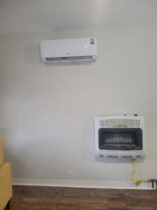 An indoor Della mini-split unit and wall-mounted gas heater installed by Vega Heating and Cooling in Kansas City, KS