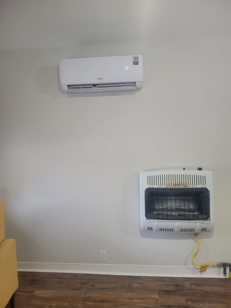 An indoor Della mini-split unit and wall-mounted gas heater installed by Vega Heating and Cooling in Kansas City, KS
